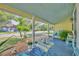 Serene front porch with light blue ceiling, table, and seating offering a relaxing outdoor space at 1110 Virginia Ave, St Cloud, FL 34769