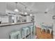 Bright kitchen featuring white cabinets, stainless steel appliances, and breakfast bar at 1110 Virginia Ave, St Cloud, FL 34769