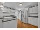 Bright kitchen featuring white cabinets, stainless steel appliances, and wood-look floors at 1110 Virginia Ave, St Cloud, FL 34769