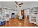 Spacious living room with hardwood floors, featuring a ceiling fan, a barn door, and comfortable seating at 1110 Virginia Ave, St Cloud, FL 34769