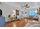 Cozy living room featuring hardwood floors, neutral tones, and a sliding barn door at 1110 Virginia Ave, St Cloud, FL 34769