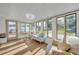 Bright sunroom features lots of natural light, wood floors, and a comfortable seating area at 1110 Virginia Ave, St Cloud, FL 34769