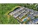 Aerial shot showcases modern townhomes next to a tranquil pond and a community pool at 1123 Mahonia Ct, Lake Mary, FL 32746