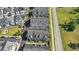 Aerial view of townhomes featuring street parking and well-maintained landscaping along a roadway at 1123 Mahonia Ct, Lake Mary, FL 32746