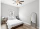 Light-filled bedroom with wood floors and gold framed mirror at 1123 Mahonia Ct, Lake Mary, FL 32746