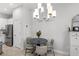 Bright dining area features a modern chandelier, table with four chairs, and access to the kitchen at 1123 Mahonia Ct, Lake Mary, FL 32746