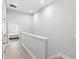 Hallway featuring wood floors, access to bedrooms and stairwell at 1123 Mahonia Ct, Lake Mary, FL 32746
