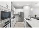 Bright kitchen features stainless appliances, stone counters, white cabinets, and wood-look tile flooring at 1123 Mahonia Ct, Lake Mary, FL 32746