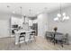 Modern kitchen and dining area features stainless appliances, shaker cabinets, island, and pendant lights at 1123 Mahonia Ct, Lake Mary, FL 32746