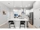 Open kitchen features stainless appliances, island with counter seating, and shaker cabinets at 1123 Mahonia Ct, Lake Mary, FL 32746