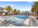 Resort-style pool area with lounge chairs, palm trees, and shaded pergolas for relaxation at 1123 Mahonia Ct, Lake Mary, FL 32746