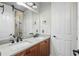 Bathroom featuring dual sinks, wooden cabinets, and modern black fixtures at 11345 Preserve View Dr, Windermere, FL 34786