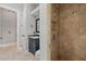 Bathroom with stylish vanity, shower with decorative tile accents, and neutral-toned travertine flooring at 11345 Preserve View Dr, Windermere, FL 34786