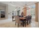 Inviting dining area with chandelier lighting, travertine floors, and views into the office and living room at 11345 Preserve View Dr, Windermere, FL 34786