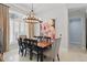 Formal dining room features modern lighting, a large picture window, and stylish furnishings at 11345 Preserve View Dr, Windermere, FL 34786