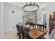 Stylish dining room with chandelier, wood table and open living area at 11345 Preserve View Dr, Windermere, FL 34786
