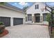 Elegant home featuring a manicured lawn, stone accents, a three-car garage, and a large paved driveway at 11345 Preserve View Dr, Windermere, FL 34786