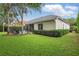 Well-manicured backyard with lush landscaping and a screened lanai and pool area at 11345 Preserve View Dr, Windermere, FL 34786