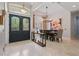 Elegant foyer with decorative glass double doors, travertine flooring, and views into the formal dining room at 11345 Preserve View Dr, Windermere, FL 34786