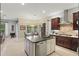 Spacious kitchen and dining area featuring a center island, gas cooktop, and bright natural light at 11345 Preserve View Dr, Windermere, FL 34786