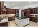 Large kitchen featuring granite counters, dark wood cabinets, and stainless steel appliances at 11345 Preserve View Dr, Windermere, FL 34786