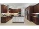 Elegant kitchen boasts custom wood cabinets, a center island, and stainless steel appliances at 11345 Preserve View Dr, Windermere, FL 34786