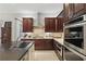 Gourmet kitchen with dark wood cabinetry, stainless appliances, and gas cooktop at 11345 Preserve View Dr, Windermere, FL 34786