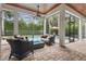 Lanai with brick flooring, ceiling fan, comfortable seating, and views of the pool and backyard at 11345 Preserve View Dr, Windermere, FL 34786