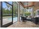 Covered lanai features brick flooring, a ceiling fan, a fire pit, and views of the pool and backyard at 11345 Preserve View Dr, Windermere, FL 34786