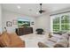 Cozy living room with entertainment center, comfortable seating, and a large window at 11345 Preserve View Dr, Windermere, FL 34786