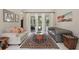 Inviting living room with a comfortable seating arrangement, patterned rug, and sliding doors to the lanai at 11345 Preserve View Dr, Windermere, FL 34786