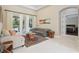 Comfortable living area with views of the patio, a stylish rug, and neutral colored furniture at 11345 Preserve View Dr, Windermere, FL 34786