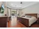 Spacious main bedroom with hardwood floors, tray ceiling, and pool views at 11345 Preserve View Dr, Windermere, FL 34786