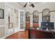 Charming office with wood floors, built-in shelving, and glass paneled doors leading to another room at 11345 Preserve View Dr, Windermere, FL 34786