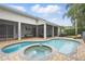 Inviting backyard pool and spa with a brick surround, screened-in lanai, and lush landscaping at 11345 Preserve View Dr, Windermere, FL 34786