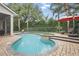Private backyard pool area with sun loungers and tropical plants, perfect for outdoor relaxation at 11345 Preserve View Dr, Windermere, FL 34786
