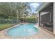 Inviting swimming pool and spa with a screened-in lanai and lush tropical landscaping at 11345 Preserve View Dr, Windermere, FL 34786