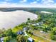 Aerial shot with a green pin, showcasing lakefront houses and greenery by the tranquil water at 12228 Kirby Smith Rd, Orlando, FL 32832
