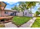 Charming backyard with a wooden deck, shed, and brick path, offering a cozy outdoor space at 12228 Kirby Smith Rd, Orlando, FL 32832