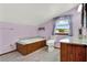 Bathroom featuring a built-in tub, tile flooring, and vanity with marble countertop at 12228 Kirby Smith Rd, Orlando, FL 32832