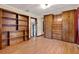 Bedroom with wood-look flooring and matching built-in closet and shelving units at 12228 Kirby Smith Rd, Orlando, FL 32832