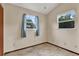 A cozy room with tile flooring, bright windows, and neutral walls offering a versatile space to relax or work at 12228 Kirby Smith Rd, Orlando, FL 32832