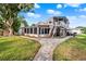 Charming home featuring a two-story design with a screened porch, and a brick walkway leading to the entrance at 12228 Kirby Smith Rd, Orlando, FL 32832
