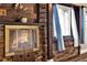 Cozy brick fireplace with wooden mantel and accents, creating a warm and inviting ambiance at 12228 Kirby Smith Rd, Orlando, FL 32832