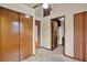 Hallway with a closet and an open doorway to a bathroom featuring tile floors and neutral-colored walls at 12228 Kirby Smith Rd, Orlando, FL 32832