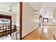 Hallway with wood floors, leading to bright rooms, highlighting the home's layout at 12228 Kirby Smith Rd, Orlando, FL 32832