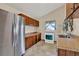 Traditional kitchen with wooden cabinets, tile floors, and a white oven, blending functionality with classic style at 12228 Kirby Smith Rd, Orlando, FL 32832