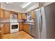 Kitchen featuring wooden cabinets, stainless steel appliances, a gas range, and neutral-toned countertops at 12228 Kirby Smith Rd, Orlando, FL 32832