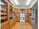 Bright kitchen featuring wooden cabinets, hardwood floors, tiled backsplash, and stainless steel refrigerator at 12228 Kirby Smith Rd, Orlando, FL 32832