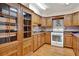 Well-lit kitchen showcasing wooden cabinets, tiled backsplash, gas range, and a full view of the space at 12228 Kirby Smith Rd, Orlando, FL 32832